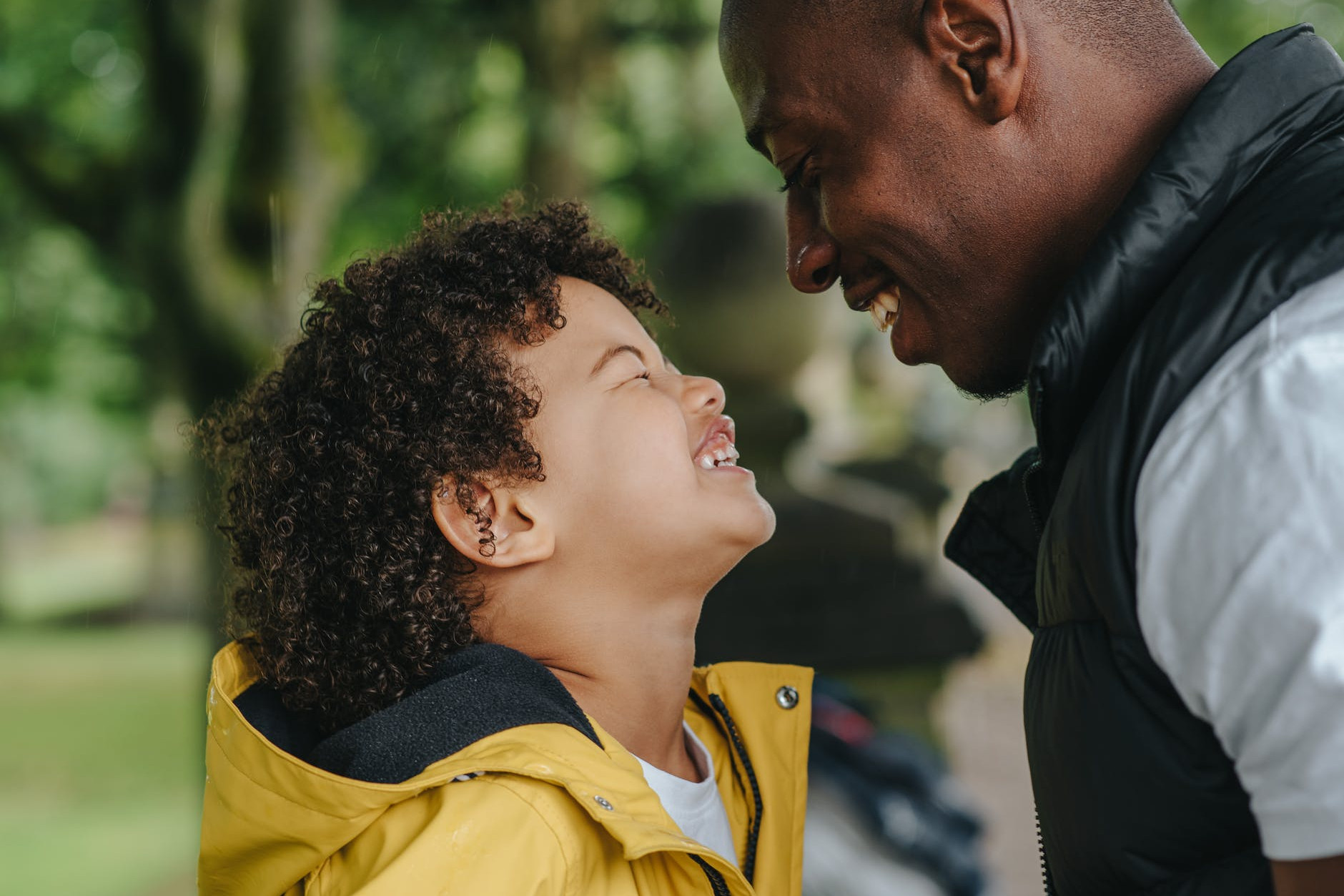 happy black father looking on little laughing sun