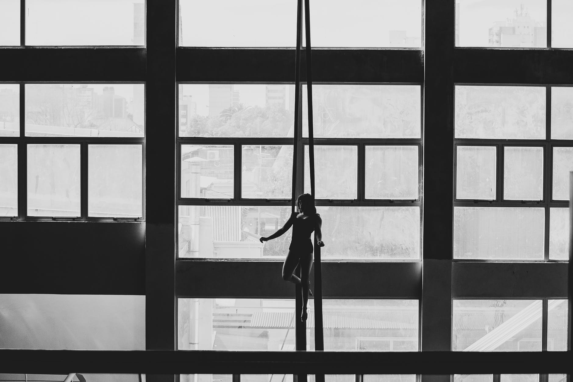 silhouette of woman standing near window