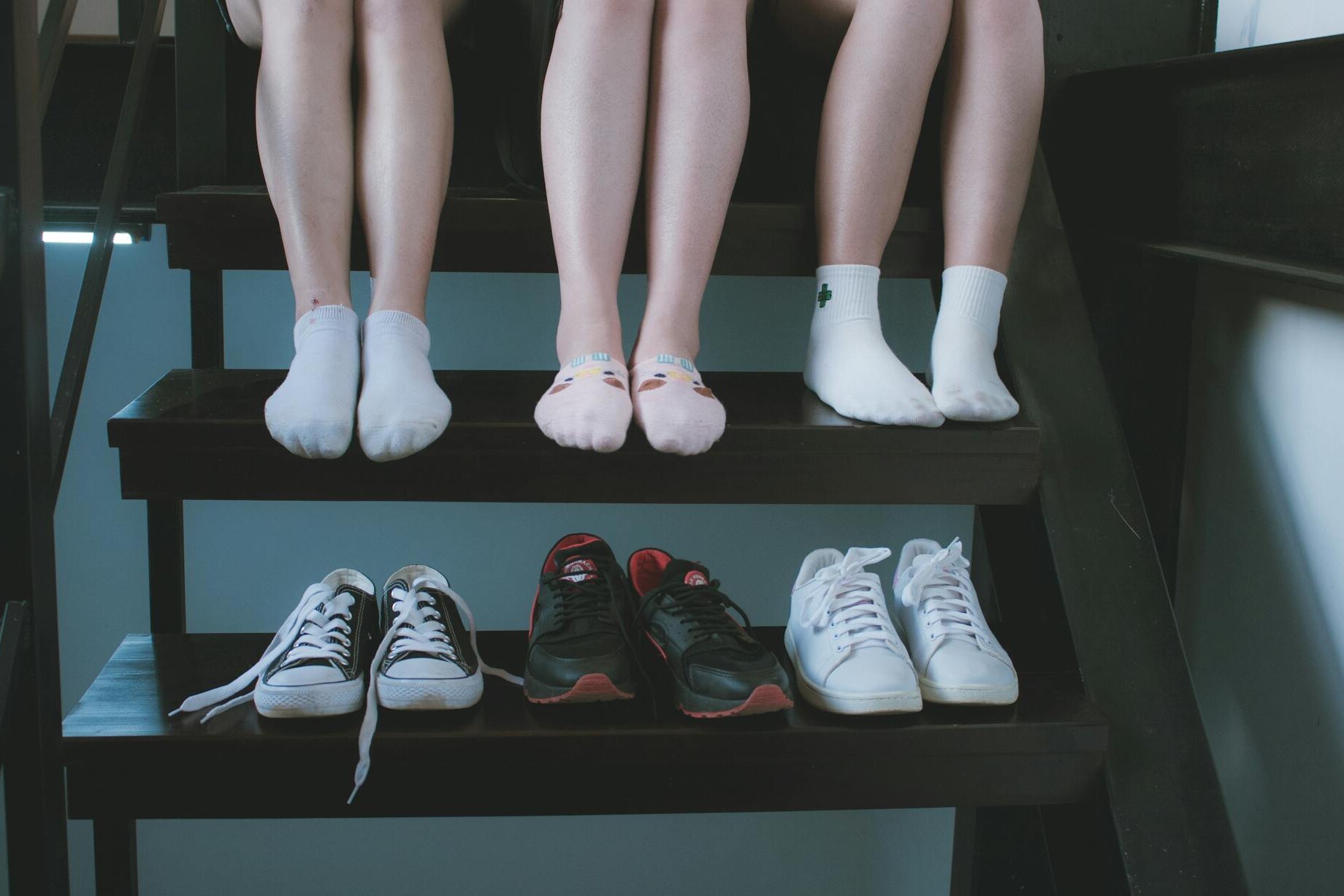 three pairs of low top sneakers